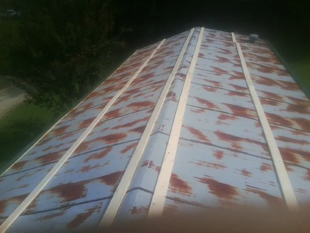 Rusted metal roof panels with new wood purlins before replacement — Storm Damage Roof Repair in Alva by Roofing Brothers